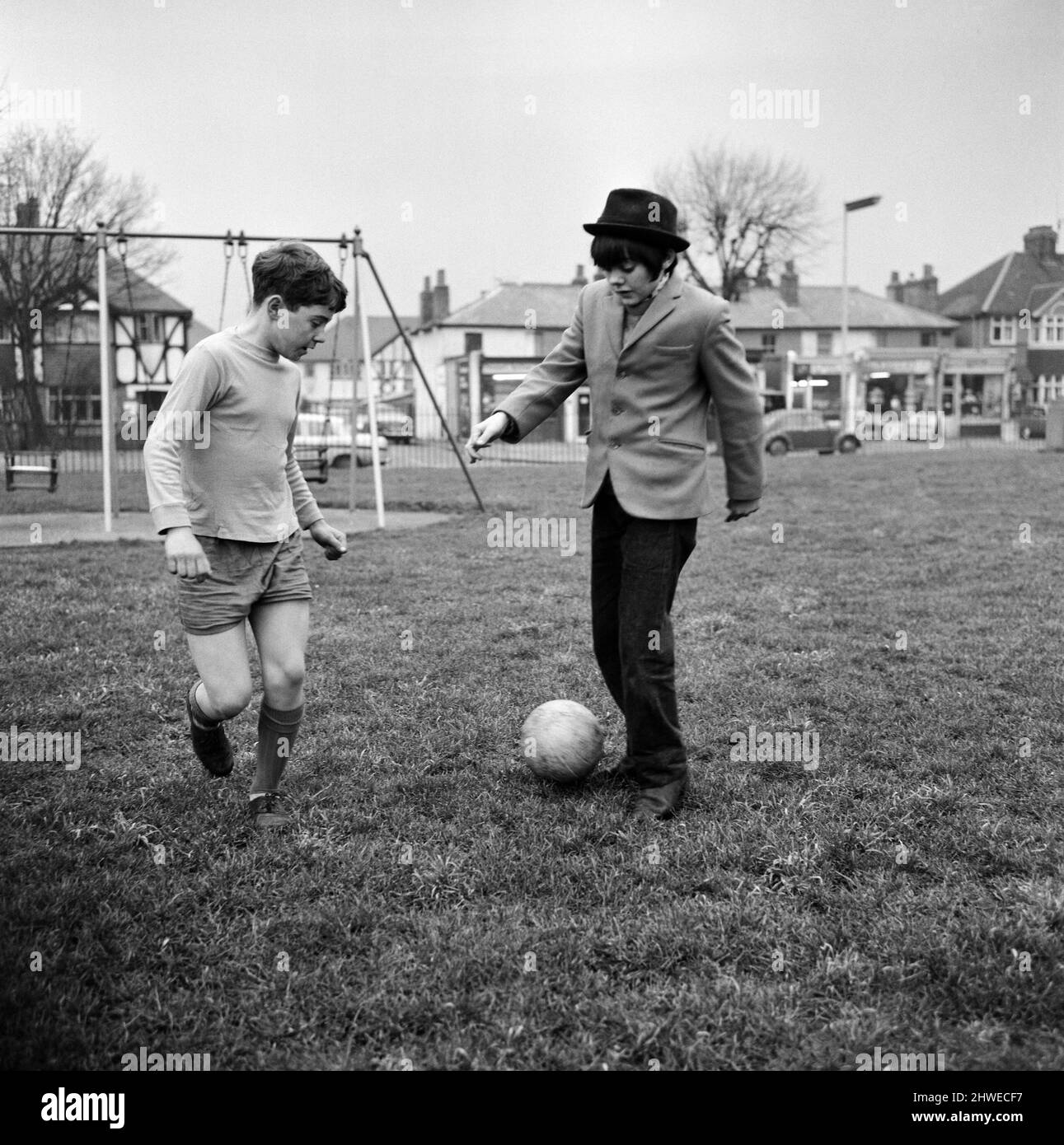 Actor Jack Wild (right) who played the role of the Artful Dodger in the 1968 Lionel Bart musical film Oliver! Pictured playing football with another boy in his local park. 28th February 1969. Stock Photo