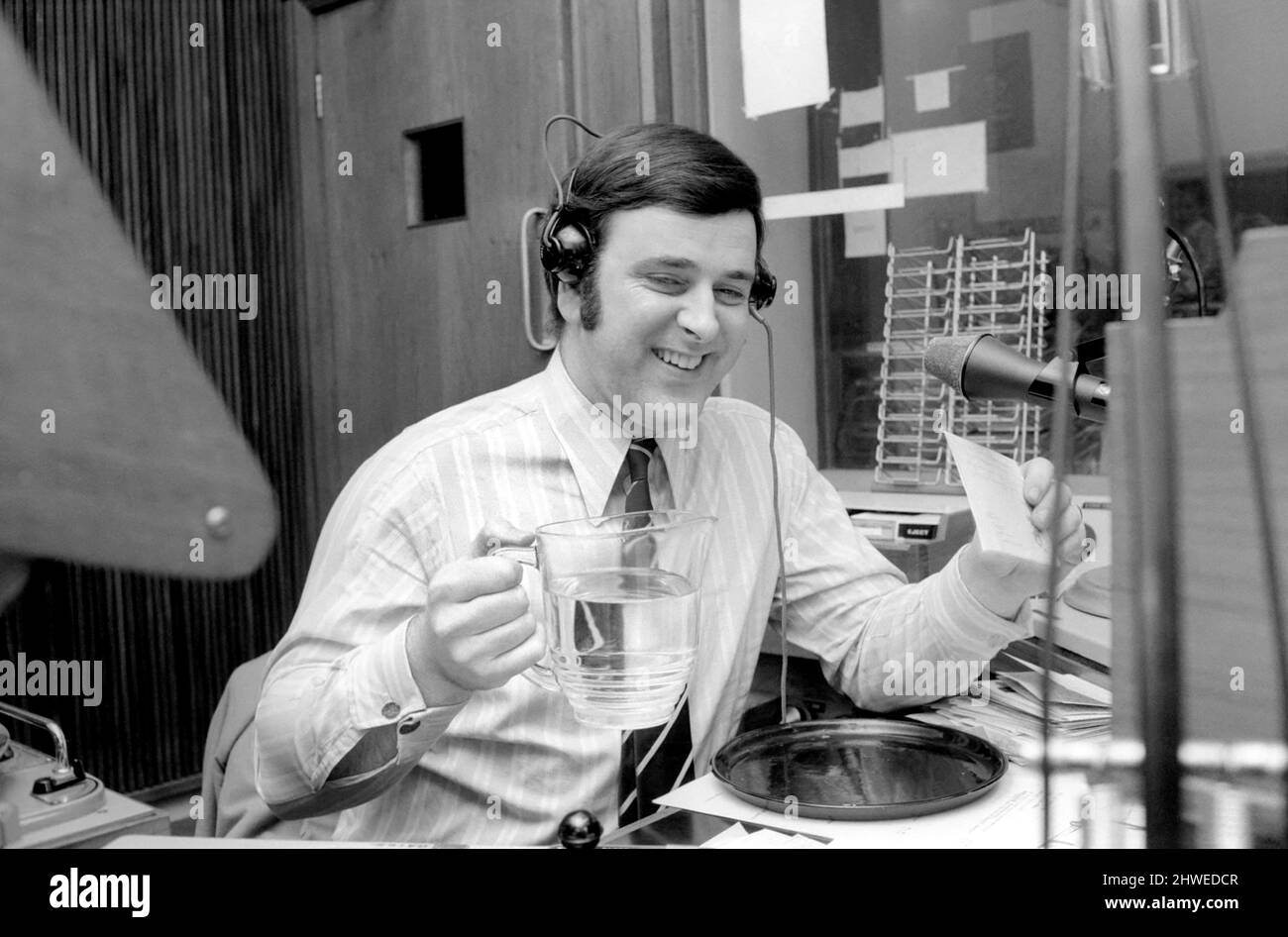 Disc Jockey Terry Wogan enjoys a large jug of water during broadcast of