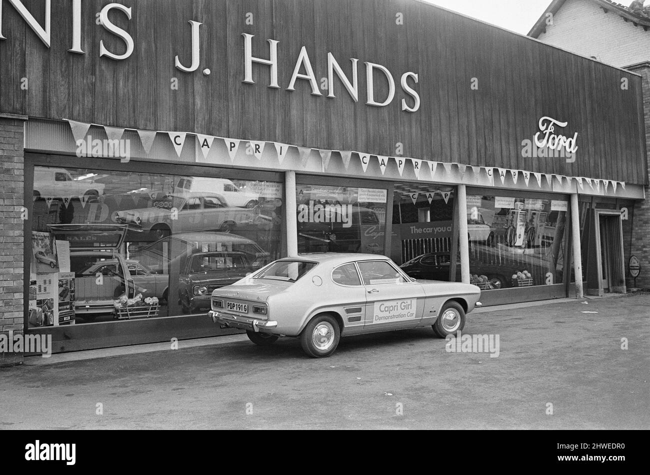 The launch of The Ford Capri Mk1.Picture taken at a showroom of car dealer Dennis J Hands in the Reading area, and shows the new Ford Capri on the forecourt, and the promotion ladies enjoying the day.  The Ford slogan, used as part of the promotion was, 'the car you have always promised yourself'  The first Ford Capri was introduced in January 1969 at the Brussels Motor Show, with sales starting the following month. The intention was to reproduce in Europe the success Ford had had with the North American Ford Mustang; to produce a European pony car  Picture taken 14th February 1969The launch o Stock Photo