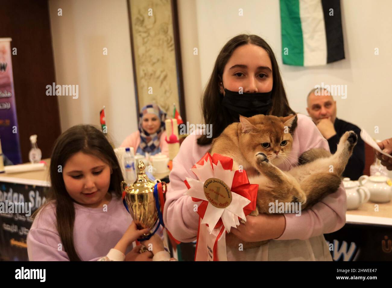 Amman, Jordan. 5th Mar, 2022. A cat owner shows off her prize-winning