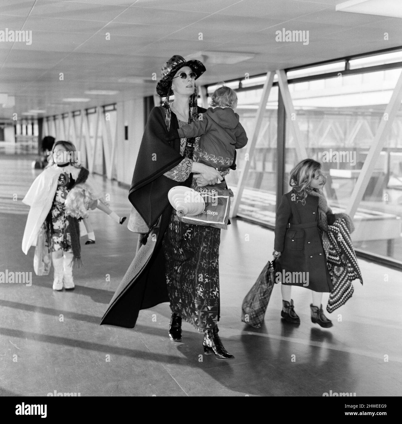 Off on a week's holiday to Rome is Vanessa Redgrave with children Natasha, 7, Joely, 5, and Carlo, 1. As they rush to catch their flight they had to be searched because the plane was going onto a security area (Middle East). Vanessa was dressed in a mauve cloak and multi coloured dress with a mauve hat, They were the last to board the place and only just made it. 26th December 1970. Stock Photo