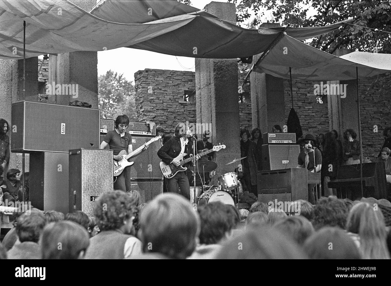 Cannon Hill Park New People Concert. 31st August 1969. They came quietly into the park. The new generation, conforming to the new rule of looking unusual, were on another of their pilgrimages to their own world of loud noise and little conversation.  This time the blues were free at a concert in Birmingham's Cannon Hill Park, but it could have been anywhere. The faces are not important: it is the look that counts.  Hair stands on end or hangs in limp tangles, the most switched-on clothes are bought secondhand, faded jeans are patched not because of holes but because of fashion. It is all an im Stock Photo