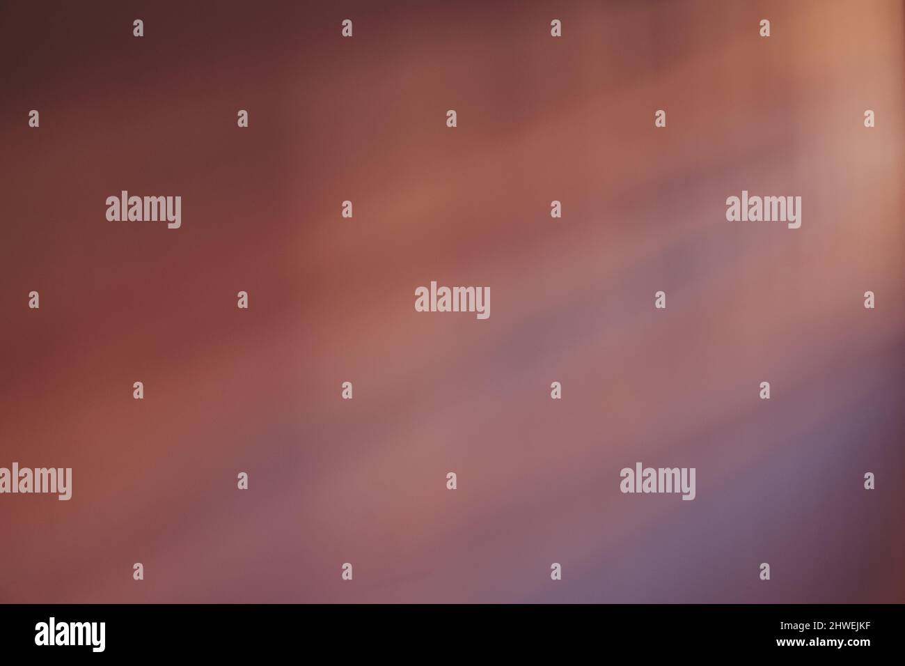 Abstract violet shadow on a wall from the window at sunset. Stock Photo