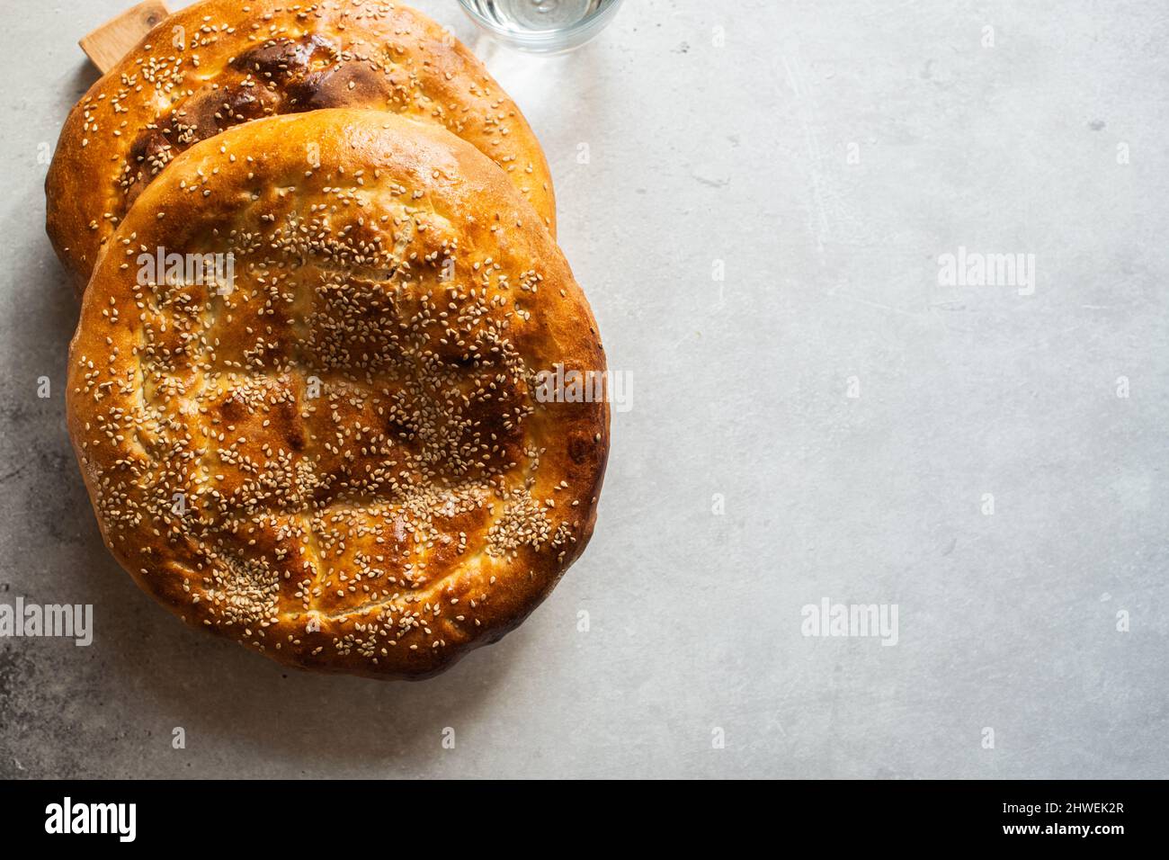 Two freshly baked flatbreads - Ramadan pide. Popular Turkish bread during Holi Ramadan Month. Copy space. Stock Photo