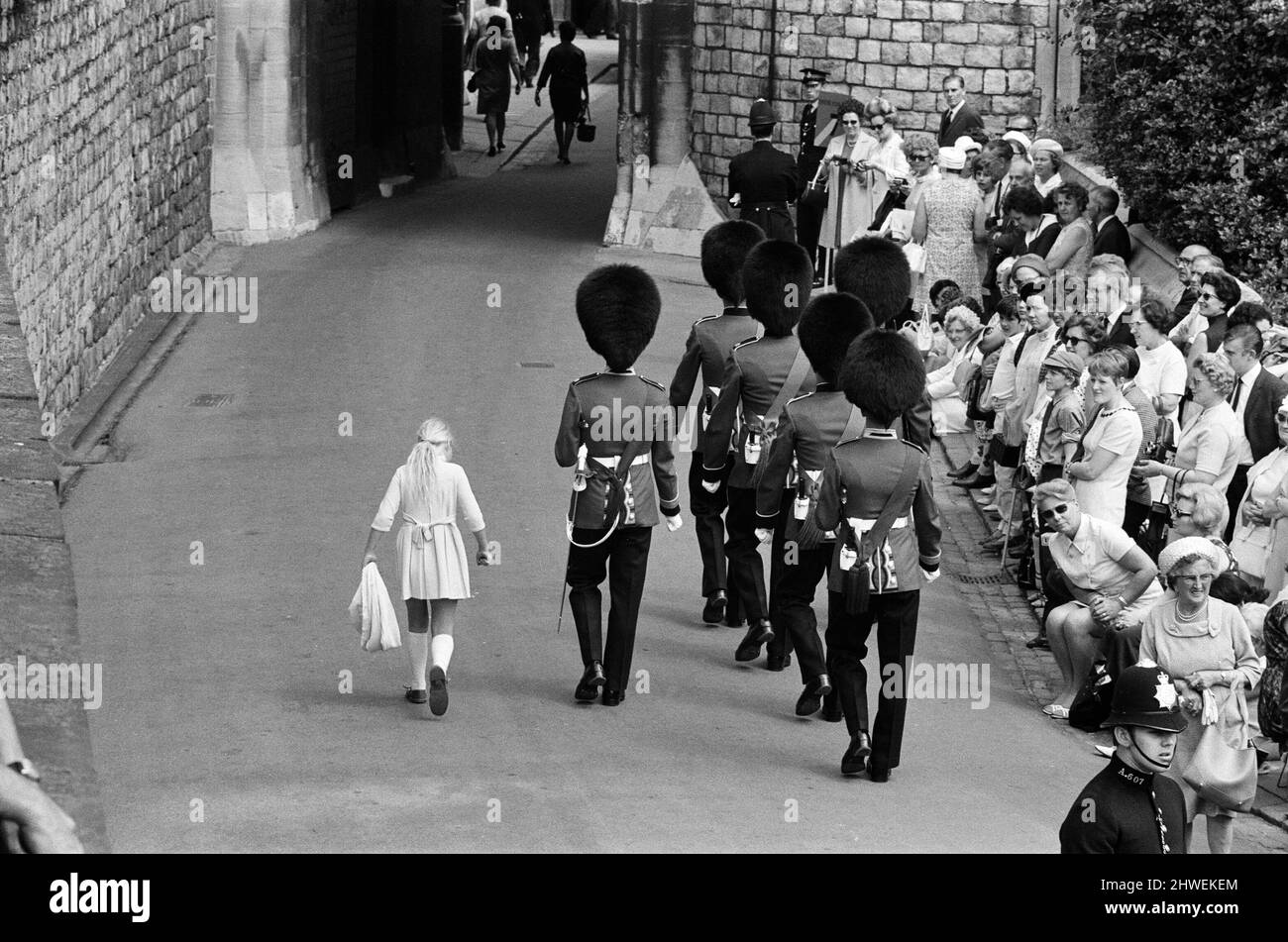 Garter Procession at Windsor Castle. A little girl joins the Guards as they march into Windsor Castle. 15th June 1970. Stock Photo