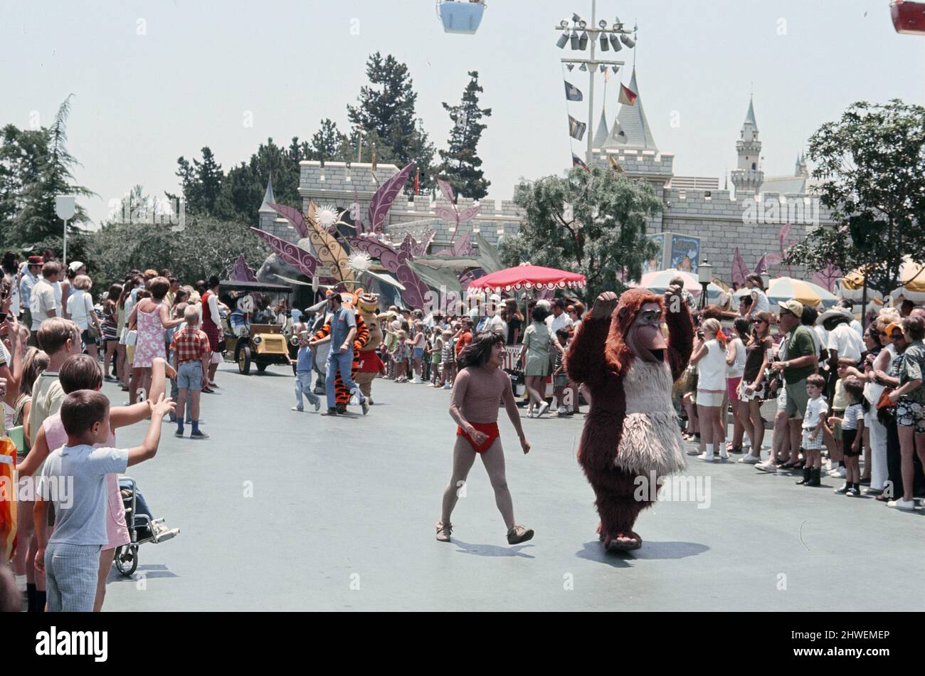 Scenes at the Disneyland theme park in Anaheim, California, United States.  Jungle book characters Mowgli and Baloo during the Main Street parade.  June 1970. Stock Photo