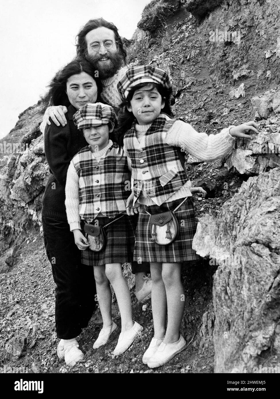 Yoko Ono  and John Lennon stand on mountain side with Julian Lennon and Kyoko. Both children dressed in kilts tartan caps and waistcoats Pictured 2nd July 1969. Stock Photo