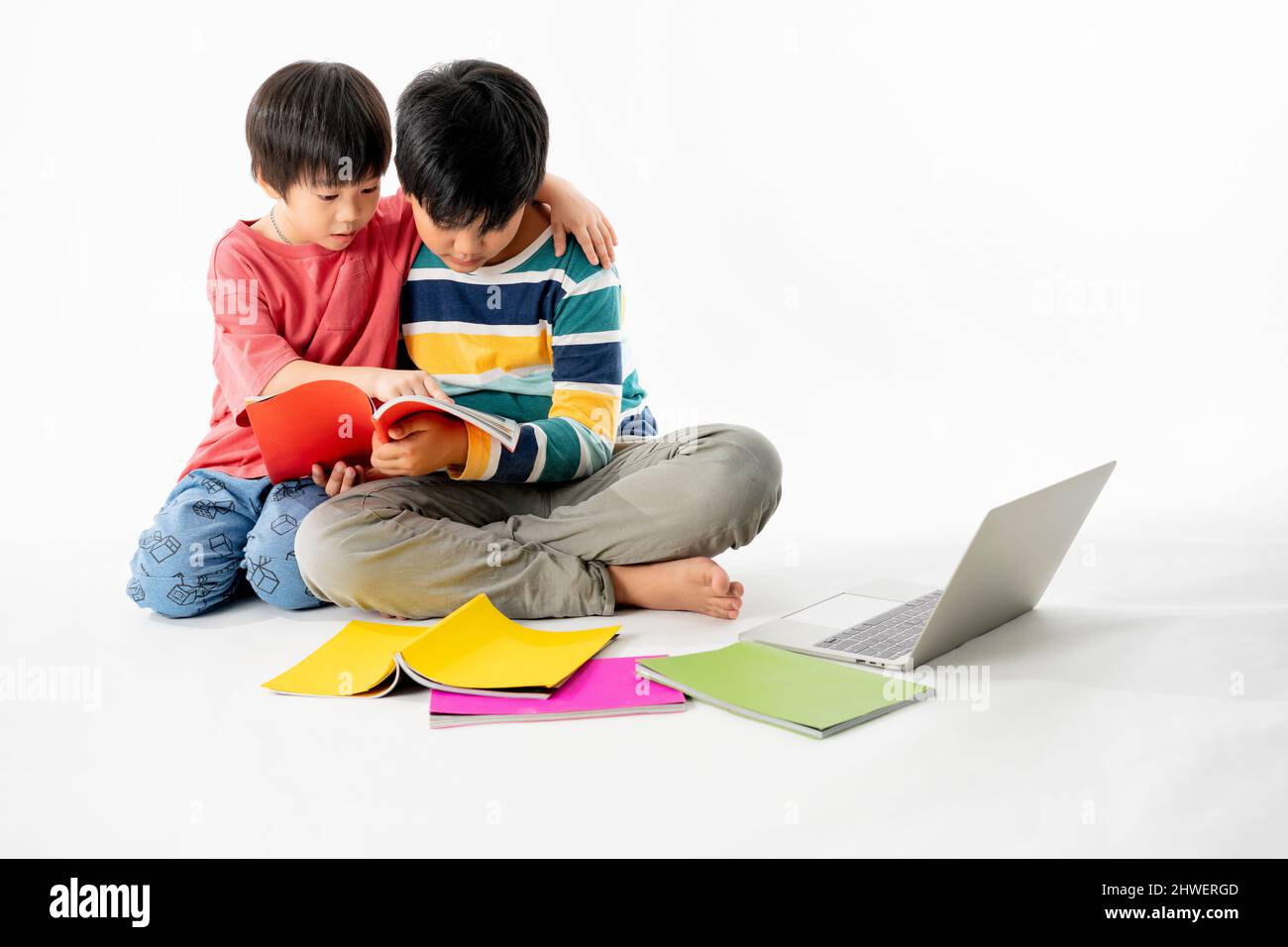Portrait of Happy asian boys, Brother on floor with laptop and books ...