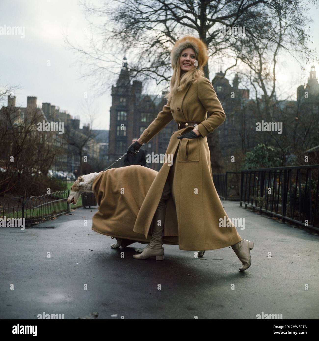 The first maxi coat for dogs gets its maiden outing in London with model Vicki Hodge and three-year-old Borzoi Sneshok Sokolova (known as Kika to her friends). Vicki's coat is by Elgee of London. January 1970. Stock Photo