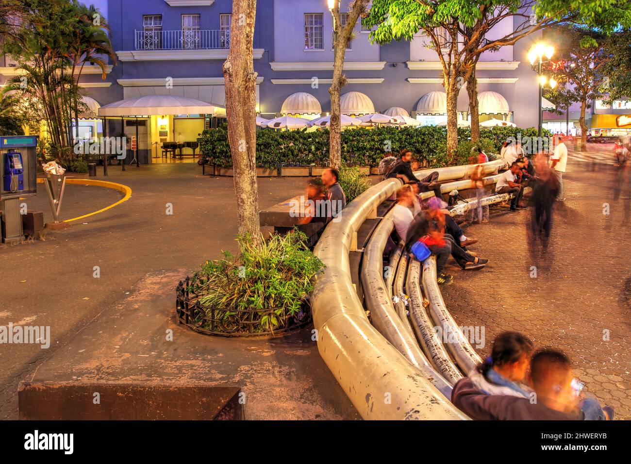 Evening scene in Plaza Juan Mora Fernàndez in downtown San Jose, Costa Rica with the Gran Hotel Costa Rica in the background. Stock Photo