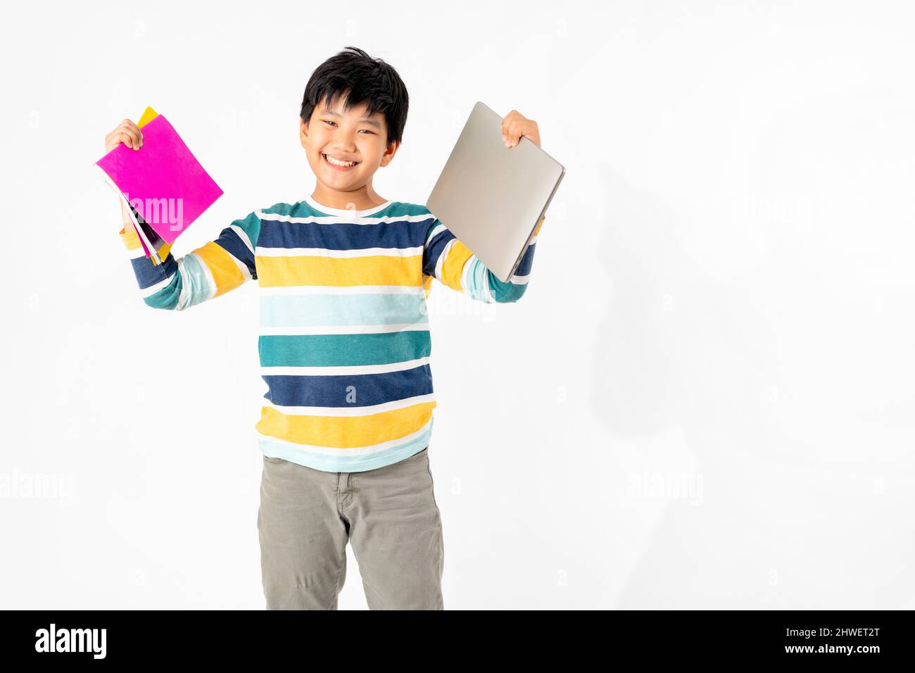 Portrait of Happy asian boy with laptop and books isolated on white ...