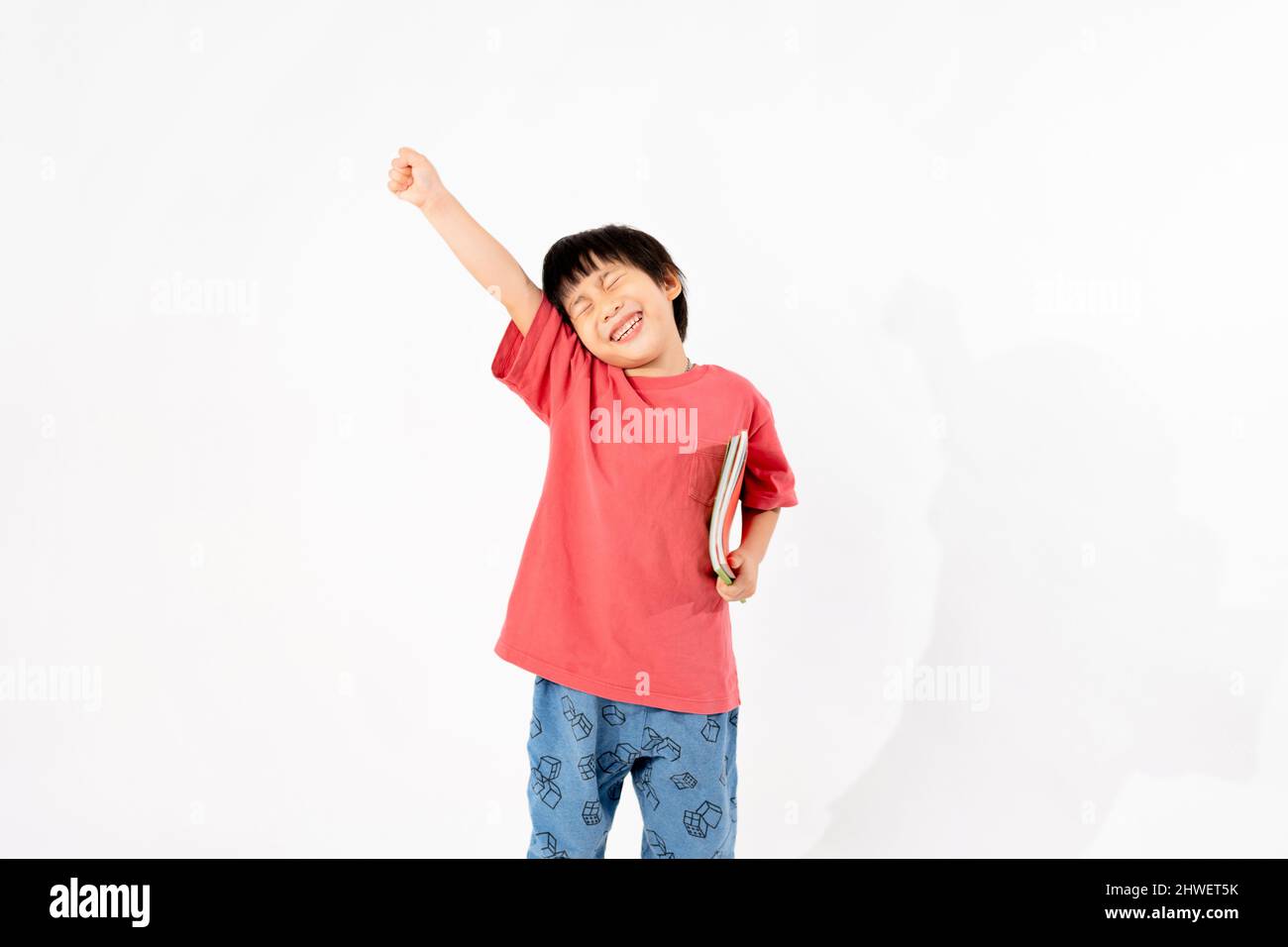 Portrait of Happy asian boy with books isolated on white background ...