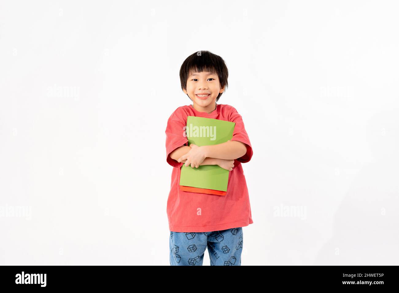 Portrait of Happy asian boy with books isolated on white background ...