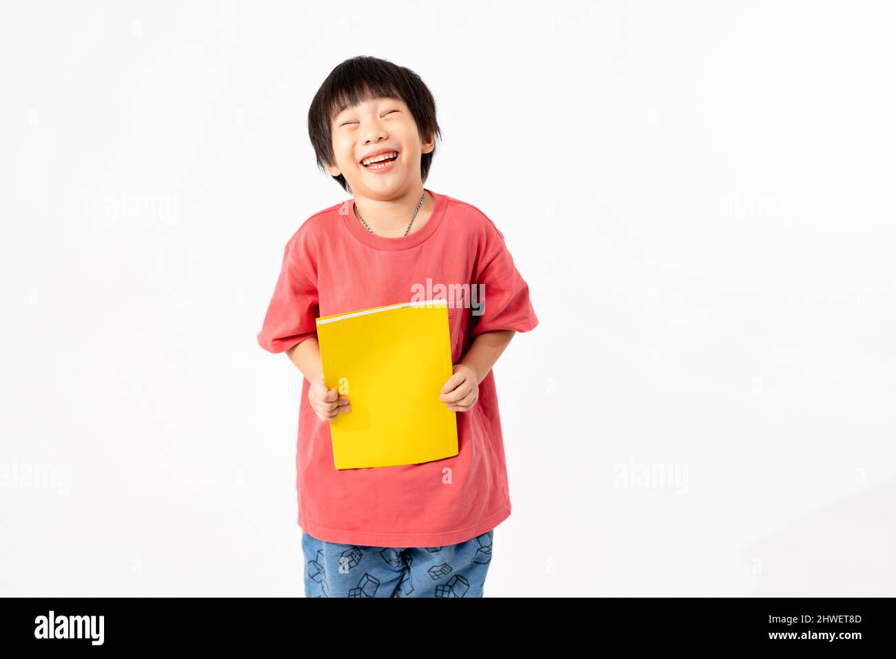 Portrait of Happy asian boy with books isolated on white background ...