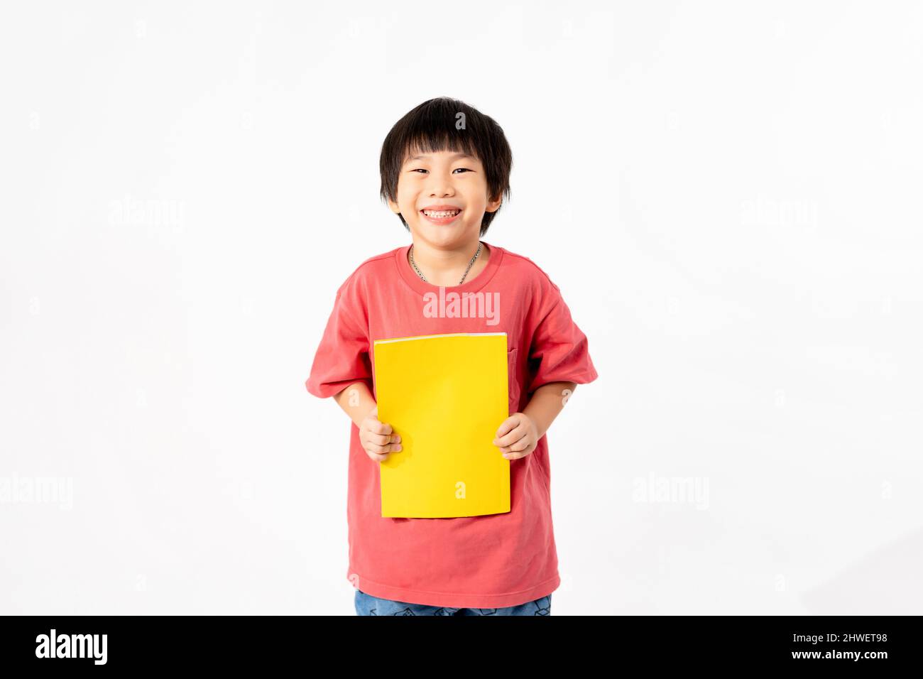 Portrait of Happy asian boy with books isolated on white background ...