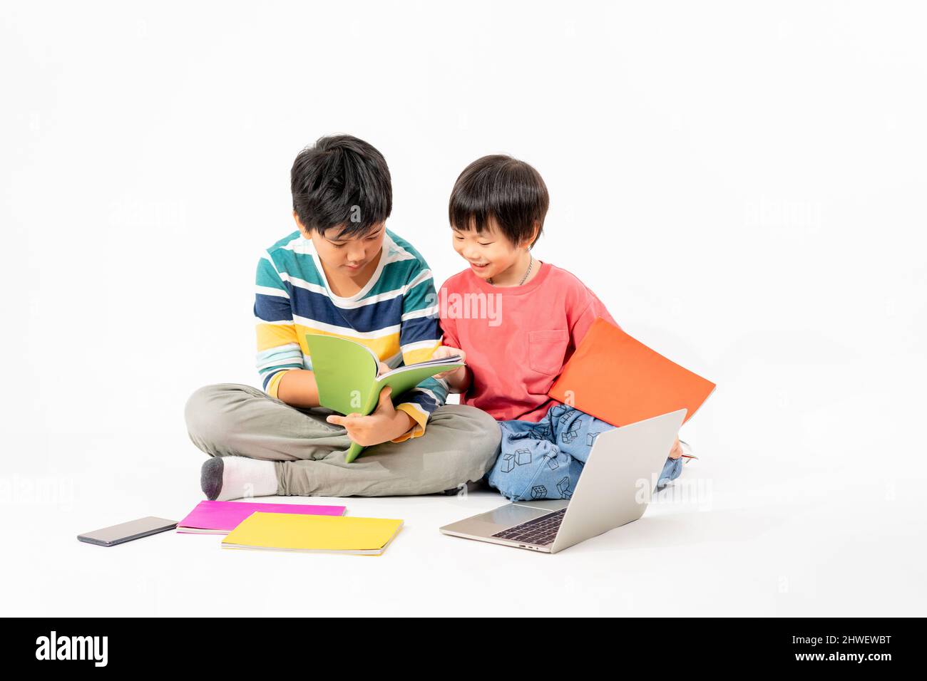 Portrait of Happy asian boys, Brother on floor with laptop and books ...