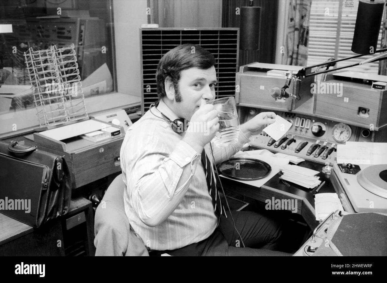 Disc Jockey Terry Wogan enjoys a large jug of water during broadcast of