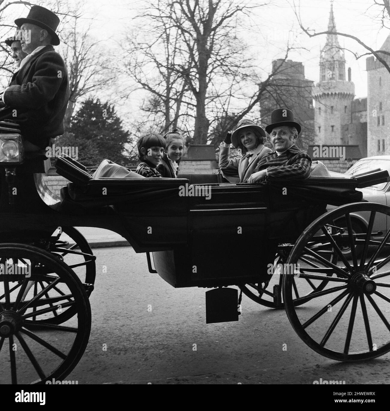 Leo Abse MP, his wife Marjorie, son Tobias and daughter Bathsheba arrive in an open horse drawn carriage to open the antiques fair at the Angel Hotel, Cardiff, Wales. 13th April 1970. Stock Photo