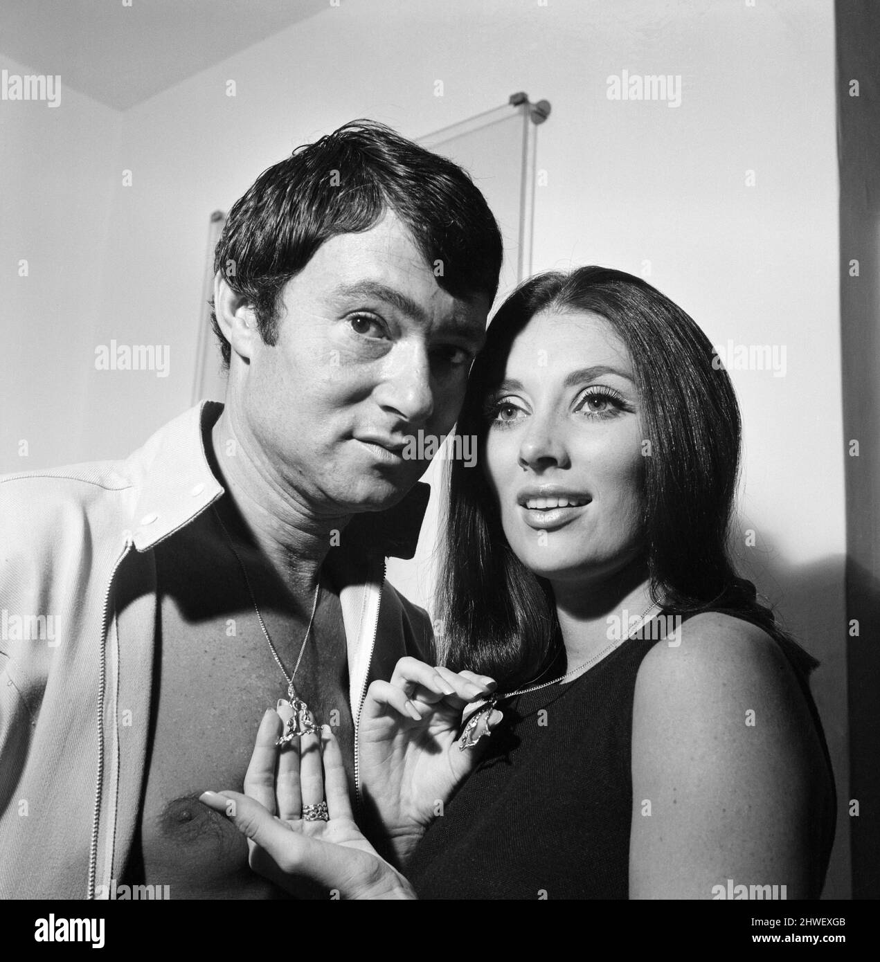 Hairstylist Vidal Sassoon and his wife Beverly, pictured in their flat. They are wearing a divided shield of David necklace decoration which when the two halves are put together, form a single shield of David. 27th August 1969. Stock Photo