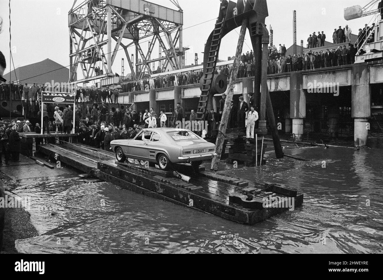 The new Ford Capri, launched in unusual manner off the slipway at the shipbuilding yard of Cammell laird in Birkenhead, Wirall. The car was launched into the Mersey with a bottle of champagne smashed onto the the bumper by Miss Liverpool Margaret Ashcroft.  5th February 1969. Stock Photo