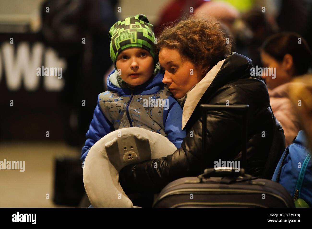 Warsaw, Warsaw, Poland. 5th Mar, 2022. At zero degree Celsius, a Ukrainian mother takes her son into her arms to keep him warm, inside a refugee centre in Warsaw, as floods of refugees escape from Ukraine to Poland, following the Russian invasion. According to the United Nations, the war has been posing threats to Children's mental health and personal safety, with nearly 7 deaths of kids reported so far. (Credit Image: © Daniel Ceng Shou-Yi/ZUMA Press Wire) Stock Photo