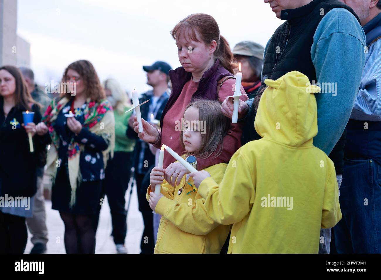 Bloomington, United States. 04th Mar, 2022. Kids hold candles as Antiwar demonstrators gather