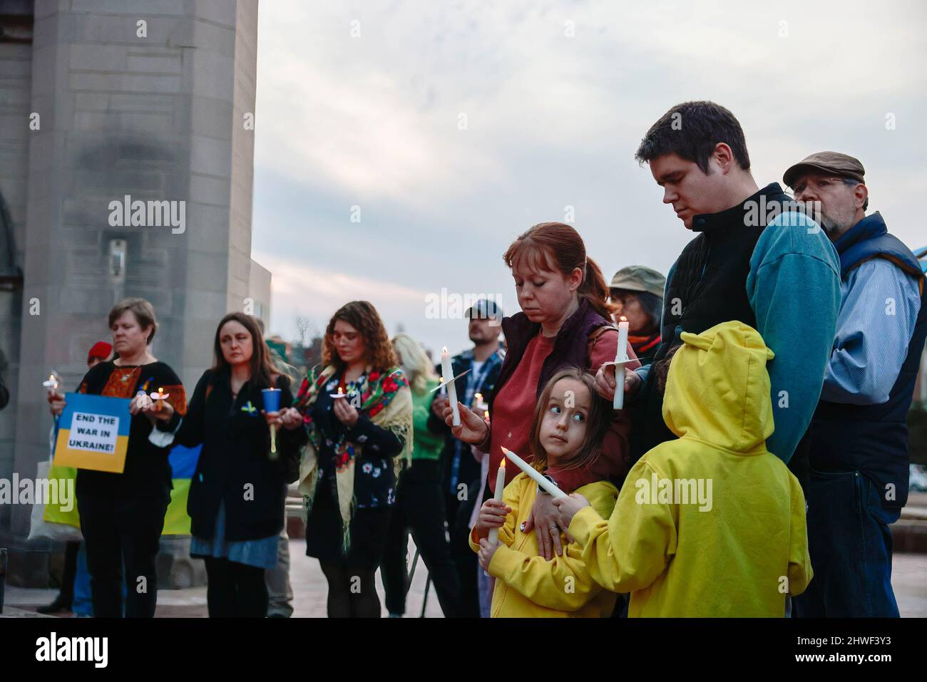 Bloomington, United States. 04th Mar, 2022. Kids hold candles as Antiwar demonstrators gather