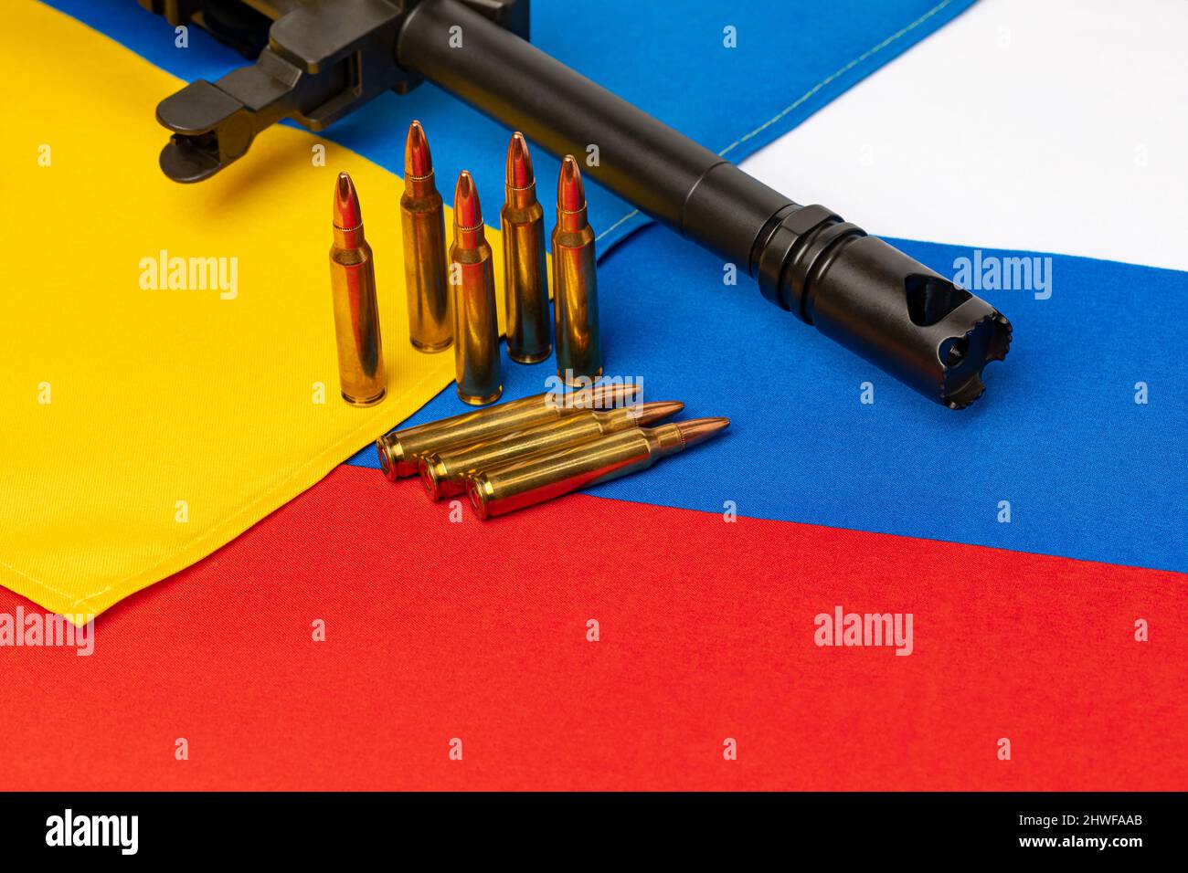 Ukraine and Russia flags with military gun and ammunition. Russian invasion, war and peace agreement treaty concept. Stock Photo