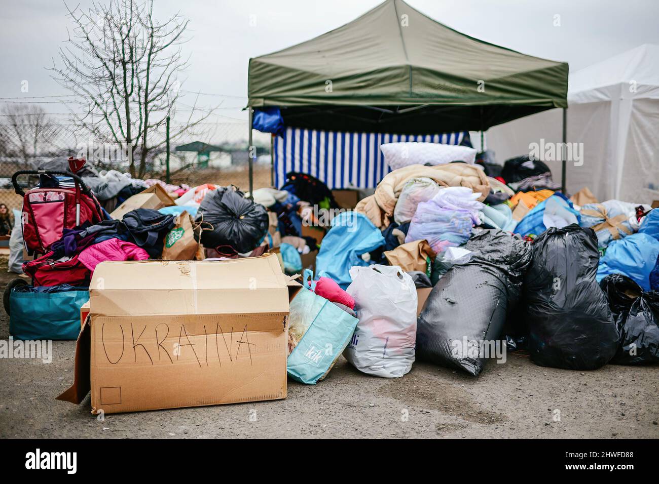 Packs with clothing prepared for the refugees, many people had to leave behind most of their everyday items, which makes this kind of help needed. Polish-Ukrainian border crossing in Medyka. Since the beginning of the Russian invasion of Ukraine, approximately 700,000 people have fled to Poland to escape the war. Despite considerable misinformation and isolated incidents, Ukrainian refugees are being welcomed with empathy, help, and understanding, but many humanitarian experts indicate that with such a huge influx of people, a crisis could occur in a few weeks. Stock Photo