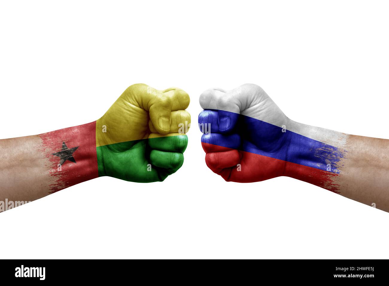 Two hands punch to each others on white background. Country flags painted fists, conflict crisis concept between guinea-bissau and russia Stock Photo