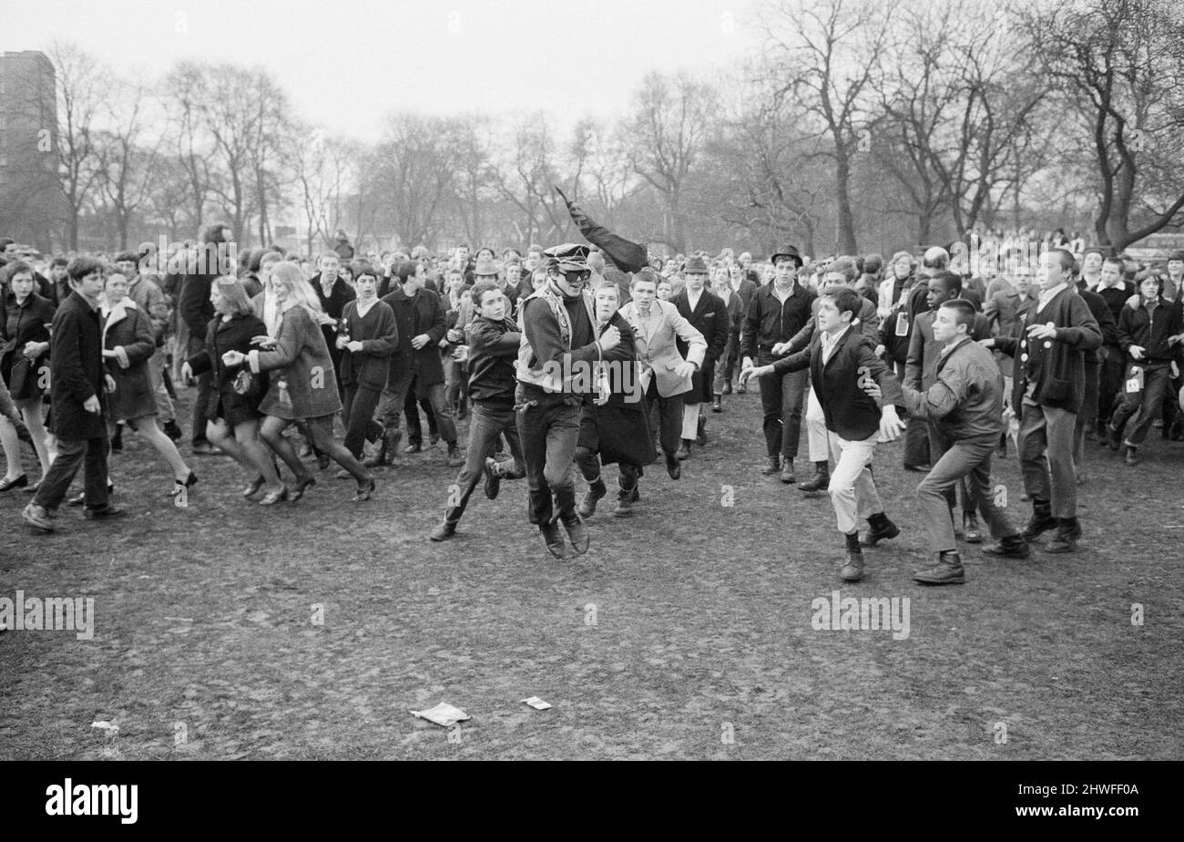 The 'Festival of Life' meeting arranged by the CND held at Victoria Park in Bethnal Green, East London. Picture shows: A lone greaser runs away from a gang of several hundred skinheads after they had spotted him beside one of the smaller stage shows. The police then escorted the youth from the park.  29th March 1970. Stock Photo