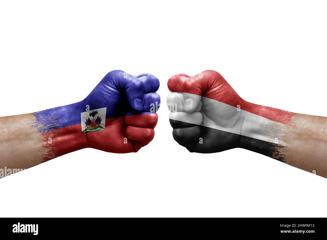 Two hands punch to each others on white background. Country flags painted fists, conflict crisis concept between haiti and yemen Stock Photo