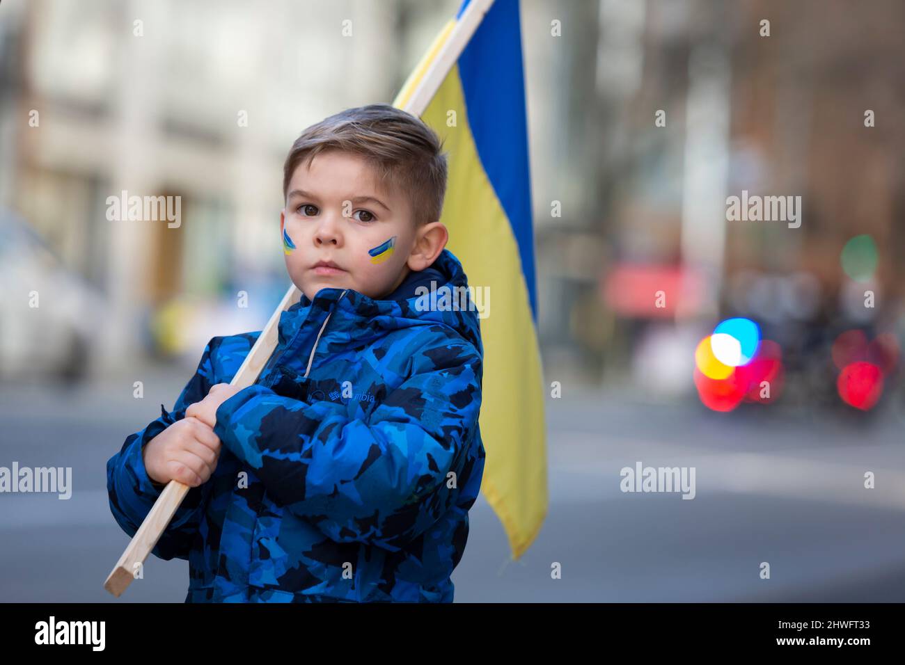 Seattle, Washington, USA. 5th March, 2022. A young boy hods a Ukrainian flag during a rally and march against the Russian invasion of Ukraine. Hundreds attended the “Ukrainian March and Rally In Seattle Against Russian War” event that was organized by the Ukrainian Association of Washington State. Credit: Paul Christian Gordon/Alamy Live News Stock Photo