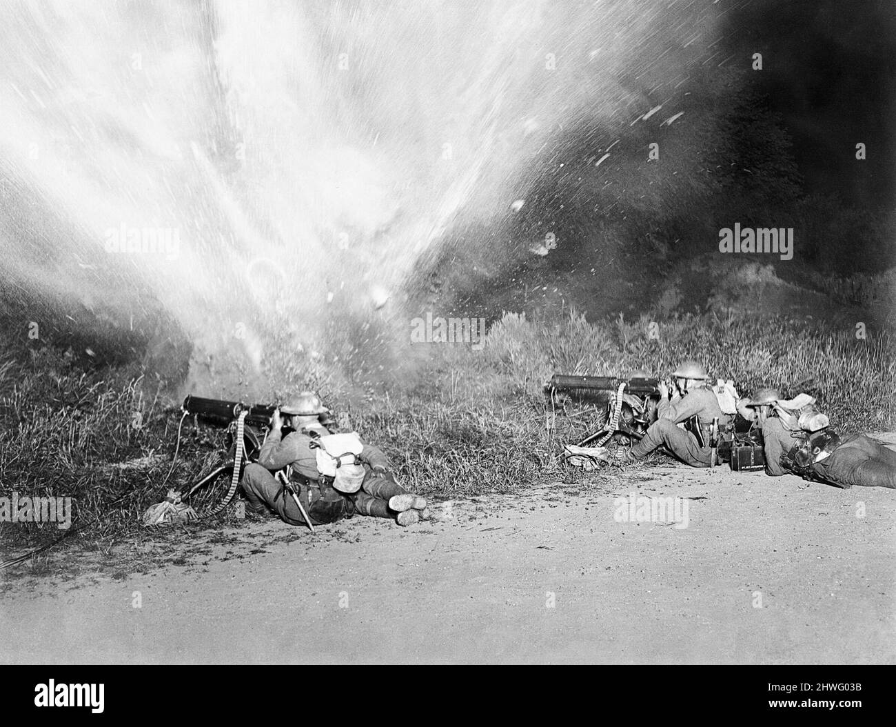Gunners firing during the explosion of a mine during training at the Machine Gun School at Rombly Stock Photo
