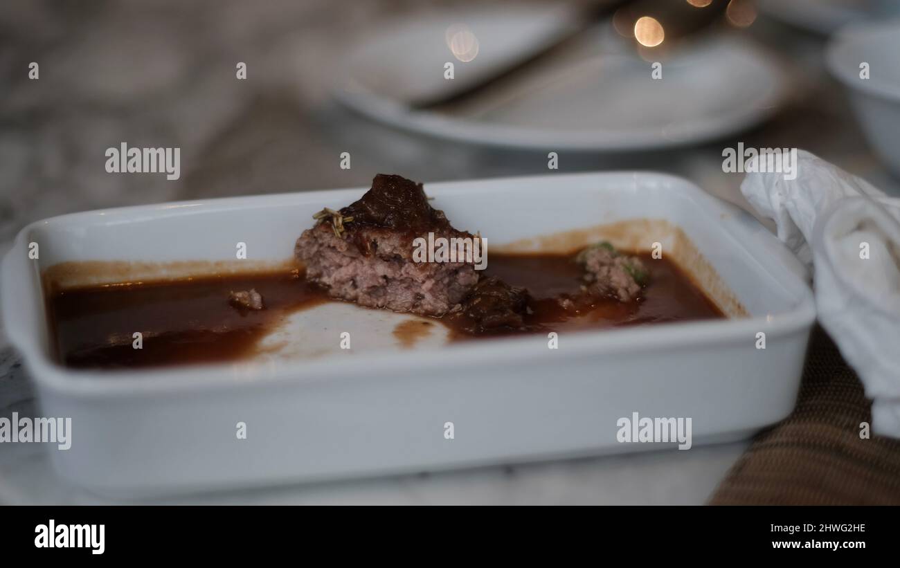 Last bite of beef hamburger meatloaf with gravy at a cafe Stock Photo