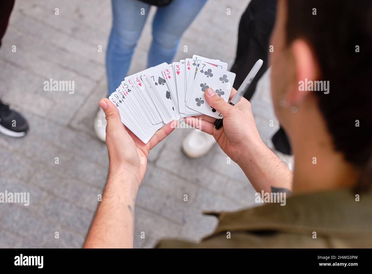 Street artist doing magic tricks with cards Stock Photo Alamy
