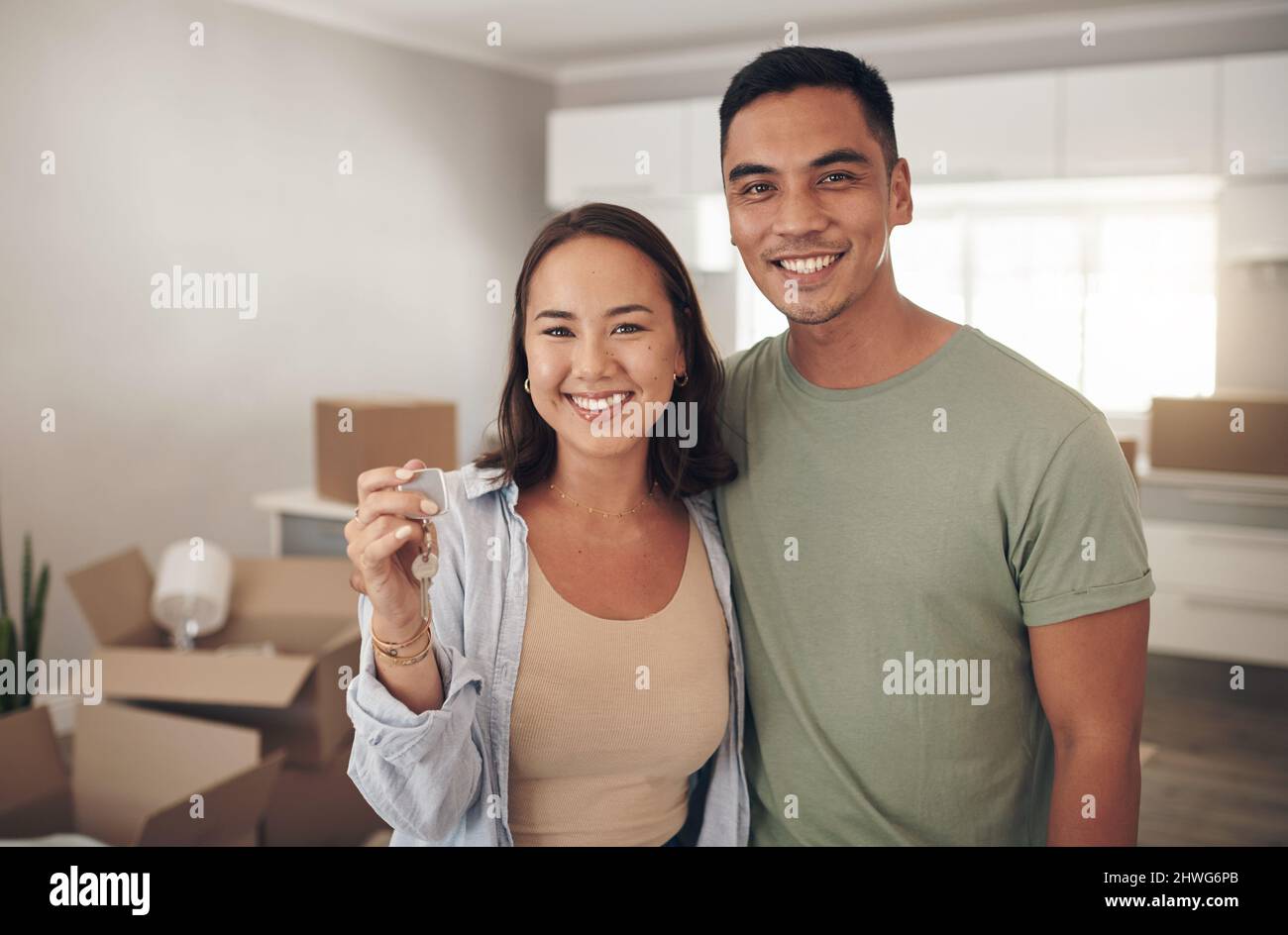 This is the key to a new beginning for us. Shot of a couple holding up ...