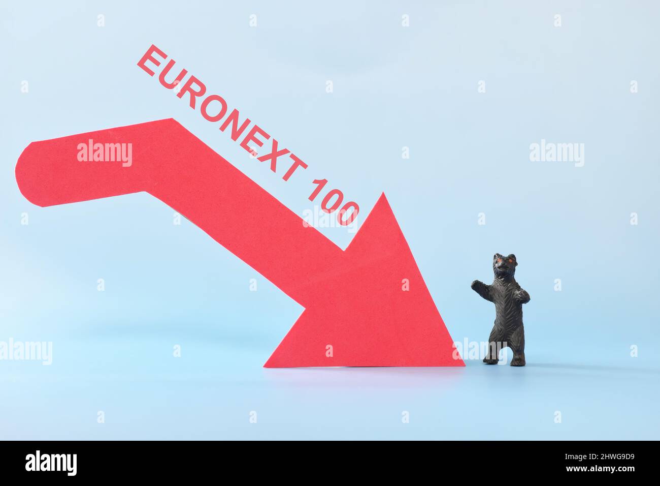 Euronext 100 index in red downward arrow with decreasing stack of coins. Bearish run in Europe European stock market. Stock Photo