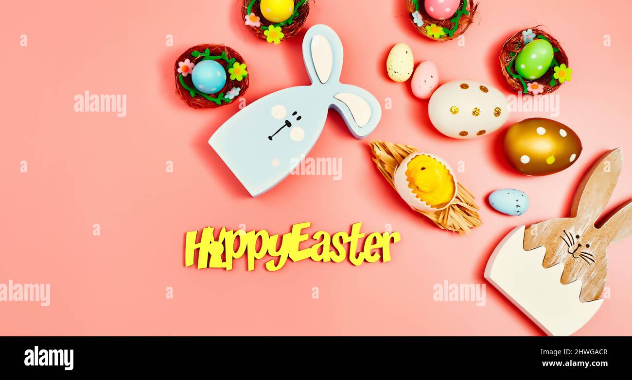 Coloeful easter eggs in nest on pink color background with space ...