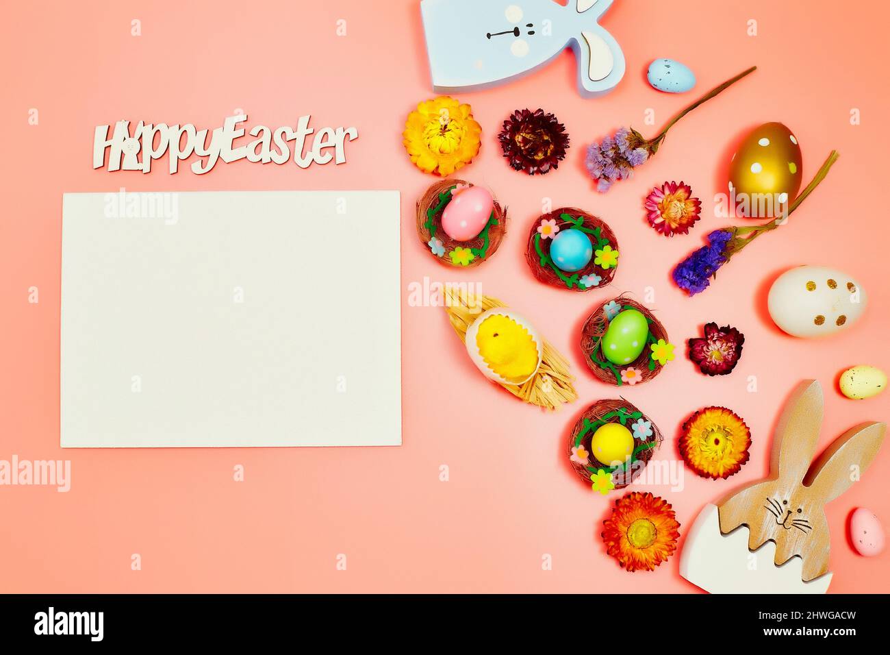 Coloeful easter eggs in nest on pink color background with space ...