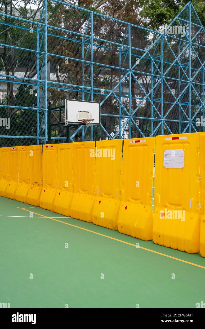 Zero Covid Hong Kong. Omicron.  2022.  Covid social restrictions in Hong Kong forcing public places and recreational facilities  to close due to Omicron. Basketball courts at a local park closed. Stock Photo