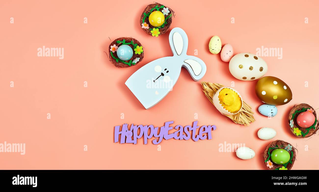 Coloeful easter eggs in nest on pink color background with space ...