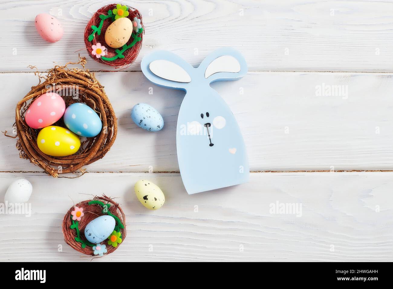 Coloeful easter eggs in nest on pink color background with space ...