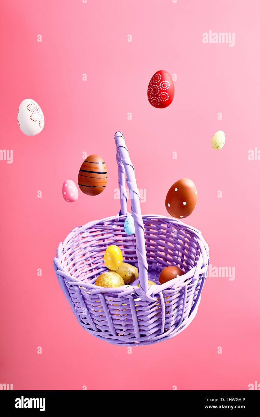 Easter eggs falling into a flying basket, Easter holiday concert Stock Photo