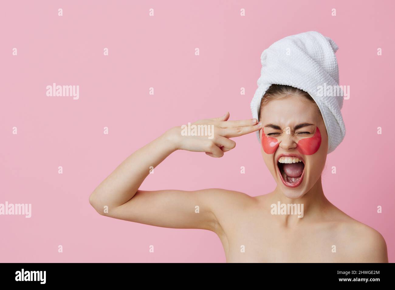 portrait-woman-pink-patches-on-the-face-with-a-towel-on-the-head-pink