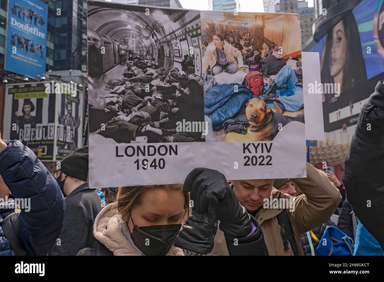 NEW YORK, NEW YORK - MARCH 05: A protester holds a sign comparing London of 1940 to Kyiv of 2022 at the 'Stand With Ukraine' rally in Times Square on March 5, 2022 in New York City. Ukrainians, Ukrainian-Americans and allies gathered to show support for Ukraine and protest against the Russian invasion. Credit: Ron Adar/Alamy Live News Stock Photo