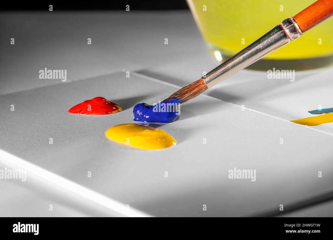 Art and craft theme showing a paintbrush tip and some pastose paint Stock Photo