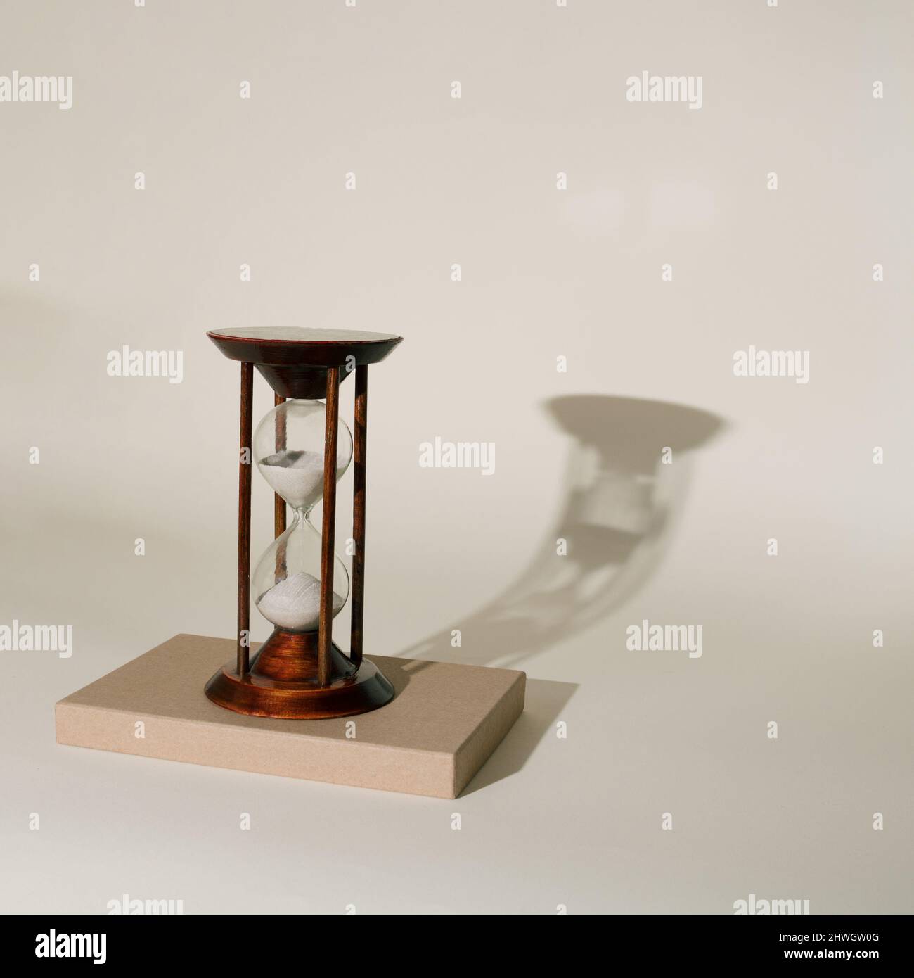Retro wooden sand clock on minimal background Stock Photo