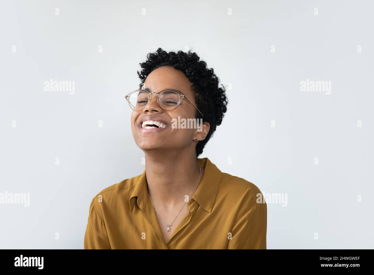 Cheerful young African business woman in casual stylish glasses Stock Photo