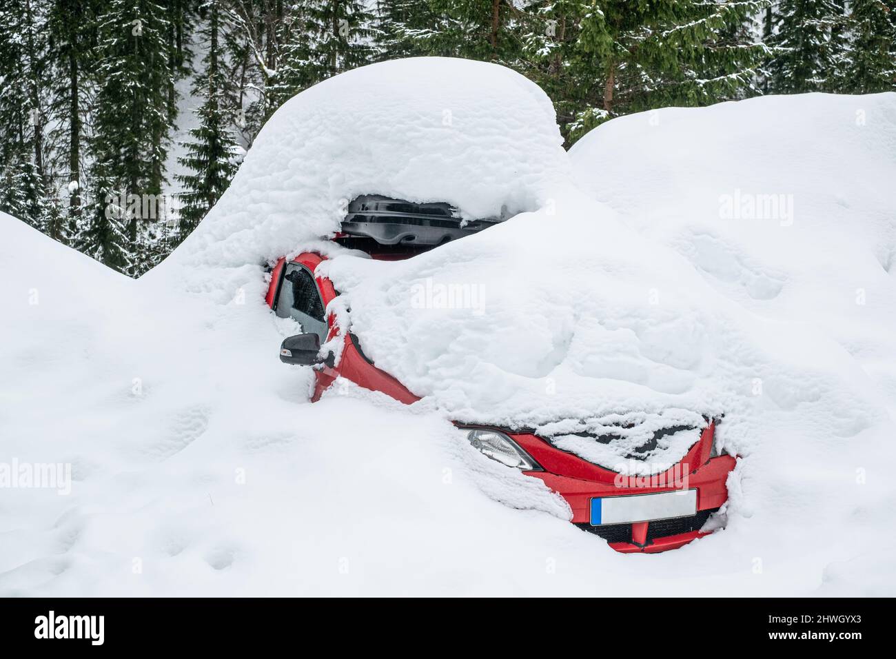 a red car covered in snow Stock Photo Alamy
